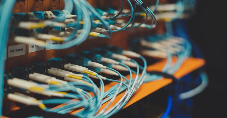 Adaptive Control - Closeup of many cables with blue wires plugged in modern switch with similar adapters on blurred background in modern studio