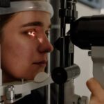 Machine Vision - Woman testing vision on microscope