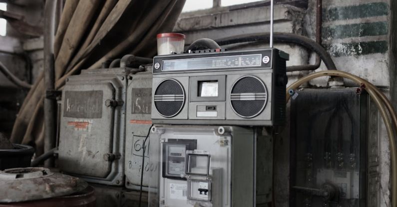 Adaptive Control Systems - Old fashioned cassette player placed in shabby garage near old industrial equipment