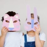 Innovative Techniques - Two Kids Covering Their Faces With a Cutout Animal Mask