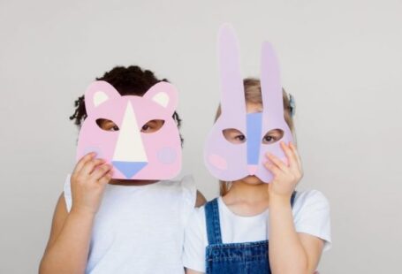 Innovative Techniques - Two Kids Covering Their Faces With a Cutout Animal Mask
