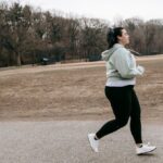 Energy Audits - Plus size woman running in autumn park