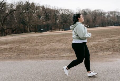 Energy Audits - Plus size woman running in autumn park