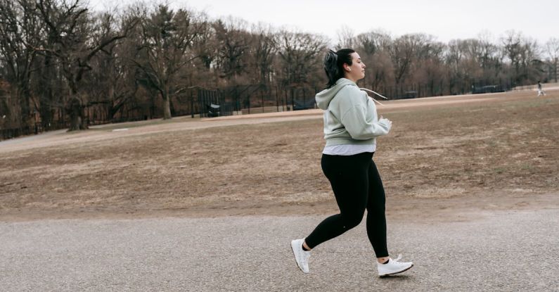 Energy Audits - Plus size woman running in autumn park