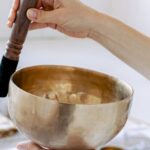 Torsional Vibration - Photo of a Person's Hands Playing a Tibetan Singing Bowl