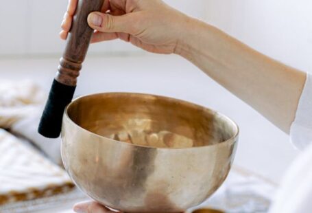 Torsional Vibration - Photo of a Person's Hands Playing a Tibetan Singing Bowl