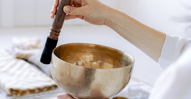 Torsional Vibration - Photo of a Person's Hands Playing a Tibetan Singing Bowl