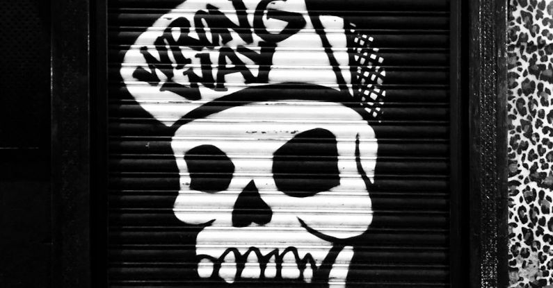 Quick Fixes - Funky skull graffiti on locked roll down black door